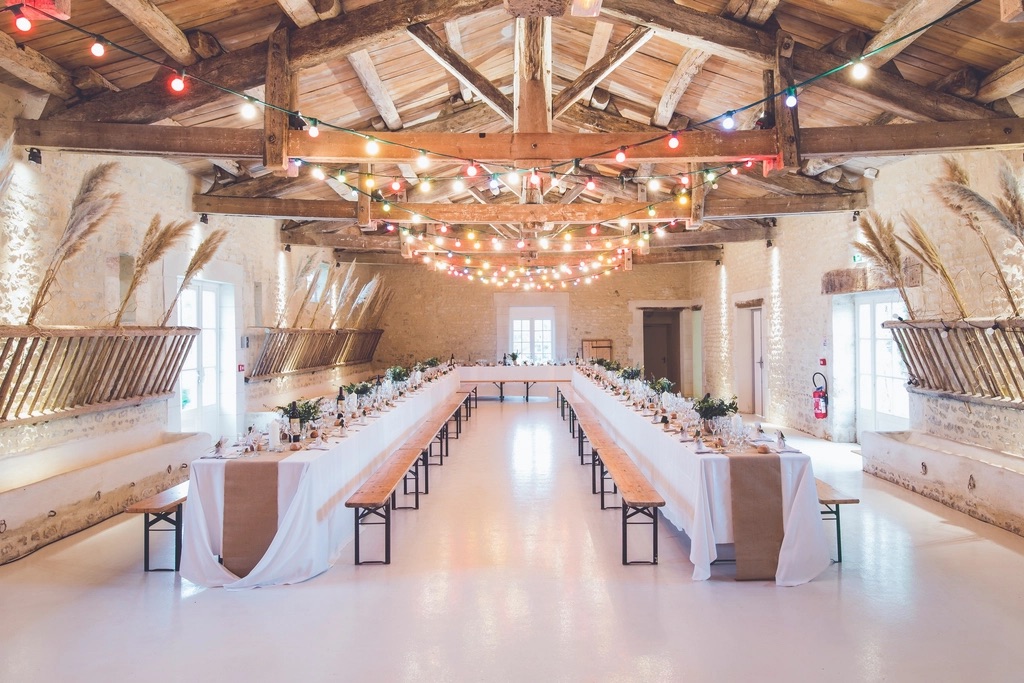 Reception hall with long tables and string lights